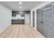 Finished basement with a small kitchen area, ample storage, and light wood floors at 1264 Six Sisters St, Dacula, GA 30019