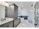 Modern bathroom with marble tile, shower, soaking tub, and dual vanity at 1264 Six Sisters St, Dacula, GA 30019