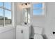 Bright, modern bathroom with white vanity, toilet, and tiled walls at 1264 Six Sisters St, Dacula, GA 30019