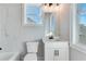 Clean bathroom featuring white vanity, toilet and tiled wall at 1264 Six Sisters St, Dacula, GA 30019