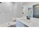 Modern bathroom featuring white subway tile, single vanity, and shower at 1264 Six Sisters St, Dacula, GA 30019