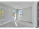 Bright bedroom with carpet and large windows overlooking nature at 1264 Six Sisters St, Dacula, GA 30019