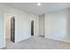 Large, carpeted bedroom with two doors, and white walls at 1264 Six Sisters St, Dacula, GA 30019
