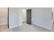 Empty bedroom with gray carpet, white walls, and ensuite bathroom at 1264 Six Sisters St, Dacula, GA 30019