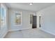 Bright bedroom with windows, carpeted floor, and access to balcony at 1264 Six Sisters St, Dacula, GA 30019