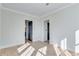 Empty bedroom with light hardwood floors and white walls at 1264 Six Sisters St, Dacula, GA 30019