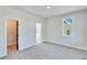 Empty bedroom with attached closet and bathroom access at 1264 Six Sisters St, Dacula, GA 30019