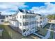 Charming white three-story home with spacious porches, situated in a lovely neighborhood at 1264 Six Sisters St, Dacula, GA 30019