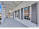 Covered front porch with concrete floor, windows, and dark shutters at 1264 Six Sisters St, Dacula, GA 30019