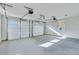 Two-car garage with white doors and concrete flooring at 1264 Six Sisters St, Dacula, GA 30019