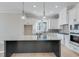 Kitchen with white cabinets, granite countertops, island, and stainless steel appliances at 1264 Six Sisters St, Dacula, GA 30019