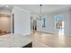 Open-concept kitchen and dining space with hardwood floors, large windows, and stylish lighting at 1264 Six Sisters St, Dacula, GA 30019