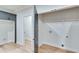 Laundry room with built-in shelving, gray cabinets, and wood-look flooring at 1264 Six Sisters St, Dacula, GA 30019