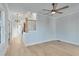 Living room with hardwood floors, ceiling fan, natural light, and view of staircase at 1264 Six Sisters St, Dacula, GA 30019