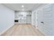 Basement room with kitchenette, wood floors, and white walls at 1274 Six Sisters St, Dacula, GA 30019