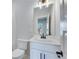 Bathroom with a white vanity, toilet, and large mirror at 1274 Six Sisters St, Dacula, GA 30019