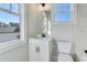 Bathroom with white vanity, toilet, and window at 1274 Six Sisters St, Dacula, GA 30019