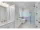 Modern bathroom featuring white cabinets, a soaking tub, a glass-enclosed shower, and tile flooring at 1274 Six Sisters St, Dacula, GA 30019