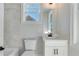 Small bathroom with white vanity, toilet, and window at 1274 Six Sisters St, Dacula, GA 30019