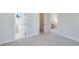 Empty bedroom with gray carpet, white walls, and an ensuite bathroom at 1274 Six Sisters St, Dacula, GA 30019