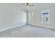 Spacious bedroom with gray carpeting, white walls, and large windows at 1274 Six Sisters St, Dacula, GA 30019