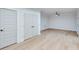 Empty bedroom with light gray walls, double French doors, and hardwood floors at 1274 Six Sisters St, Dacula, GA 30019