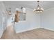 Dining room with hardwood floors, chandelier, and view of staircase at 1274 Six Sisters St, Dacula, GA 30019