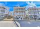 Inviting two-story home with balconies, a walkway, and landscaping at 1274 Six Sisters St, Dacula, GA 30019