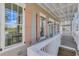 Covered porch with wooden decking, white railing, and charming shutters at 1274 Six Sisters St, Dacula, GA 30019