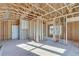 A framed, unfinished room with exposed wooden beams, studs, and natural light at 1274 Six Sisters St, Dacula, GA 30019