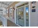 Front door with glass panels, sidelights, and charming outdoor lighting at 1274 Six Sisters St, Dacula, GA 30019