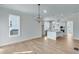 Open concept kitchen and dining area with light wood floors at 1274 Six Sisters St, Dacula, GA 30019