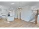 Open plan kitchen and dining area with hardwood floors at 1274 Six Sisters St, Dacula, GA 30019