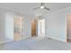 Main bedroom with gray carpeting, white walls, ensuite bathroom, and walk-in closet at 1274 Six Sisters St, Dacula, GA 30019