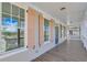 Covered porch with light tan siding, peach shutters, and windows at 1274 Six Sisters St, Dacula, GA 30019