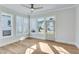 Bright sunroom with large windows, hardwood floors, and a door leading to the outside at 1274 Six Sisters St, Dacula, GA 30019