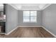 Dining area with hardwood floors and large window at 2505 Tiffany Se Ct, Conyers, GA 30013