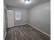 Simple bedroom with wood-look flooring and neutral walls at 4793 White Oak Path, Stone Mountain, GA 30088