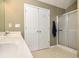 Bathroom with shower, sink, and linen closet at 1301 Crosswind Pl, Mcdonough, GA 30252