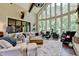Spacious Gathering room with hardwood floors, large windows, and comfortable seating at 962 Chattooga Trce, Suwanee, GA 30024