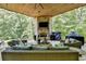Covered patio with fireplace, seating area, and built-in grill at 962 Chattooga Trce, Suwanee, GA 30024
