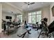 Well-equipped home gym with various exercise machines and a mirror wall at 962 Chattooga Trce, Suwanee, GA 30024
