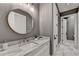 Elegant bathroom with a marble countertop and a large mirror at 962 Chattooga Trce, Suwanee, GA 30024