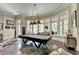 Basement game room features a pool table, large windows, and stylish decor at 962 Chattooga Trce, Suwanee, GA 30024