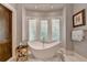Relaxing bathroom with freestanding tub and bay window at 962 Chattooga Trce, Suwanee, GA 30024