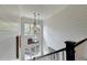Elegant staircase with three-light pendant fixture at 962 Chattooga Trce, Suwanee, GA 30024