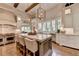 Spacious kitchen with white cabinets, marble countertops, and wood island at 962 Chattooga Trce, Suwanee, GA 30024