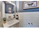 Charming powder room with shiplap and butterfly artwork at 962 Chattooga Trce, Suwanee, GA 30024