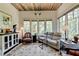 Bright sitting room boasts a cozy leather sofa and abundant natural light at 962 Chattooga Trce, Suwanee, GA 30024
