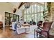 Open Gathering room with stone fireplace, hardwood floors, and abundant natural light at 962 Chattooga Trce, Suwanee, GA 30024
